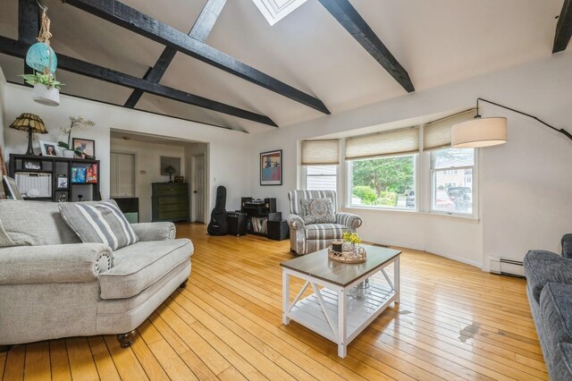 405 Waukena Ave, Oceanside, NY 11572 - living room with a baseboard radiator, light wood finished floors, and a skylight