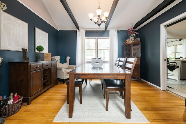 405 Waukena Ave, Oceanside, NY 11572 - dining room featuring vaulted ceiling, a chandelier, and light wood-style flooring