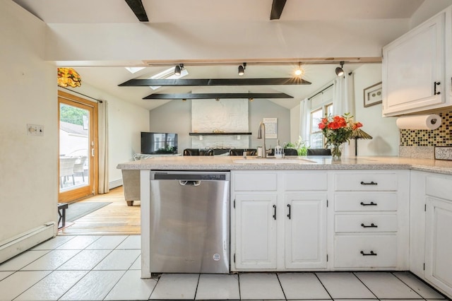405 Waukena Ave, Oceanside, NY 11572 - kitchen featuring stainless steel dishwasher, plenty of natural light, a peninsula, and backsplash