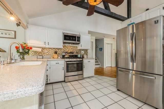 405 Waukena Ave, Oceanside, NY 11572 - kitchen featuring stainless steel appliances, light countertops, backsplash, a ceiling fan, and white cabinets