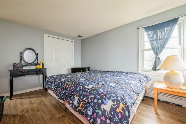 405 Waukena Ave, Oceanside, NY 11572 - bedroom featuring wood finished floors, multiple windows, and a closet