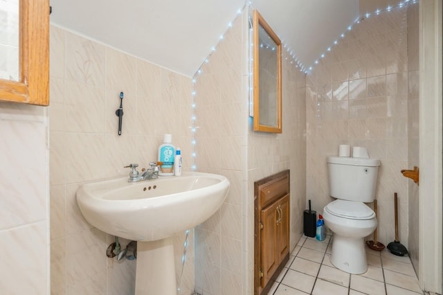 405 Waukena Ave, Oceanside, NY 11572 - bathroom with tile walls, tile patterned flooring, and lofted ceiling