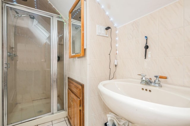 405 Waukena Ave, Oceanside, NY 11572 - full bathroom with tile walls, a shower stall, vaulted ceiling, and tile patterned flooring