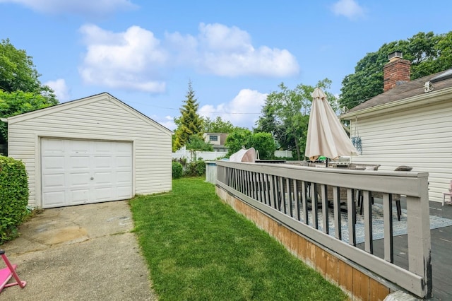 405 Waukena Ave, Oceanside, NY 11572 - view of green lawn featuring concrete driveway, an outbuilding, and a detached garage