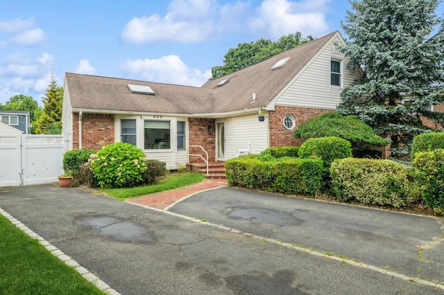 405 Waukena Ave, Oceanside, NY 11572 - view of front of property with brick siding, a shingled roof, and asphalt driveway