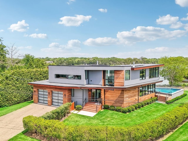 61 Harbor Dr, Sag Harbor, NY 11963 - modern home with driveway, a front yard, and a garage