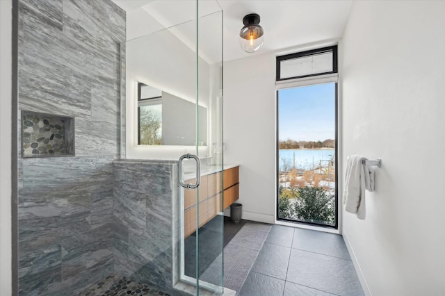 61 Harbor Dr, Sag Harbor, NY 11963 - full bathroom featuring a shower stall, tile patterned flooring, and a water view