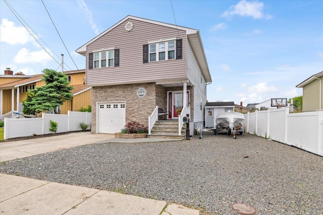 845 Atlantic St, Lindenhurst, NY 11757 - view of front of home featuring concrete driveway, stone siding, and an attached garage