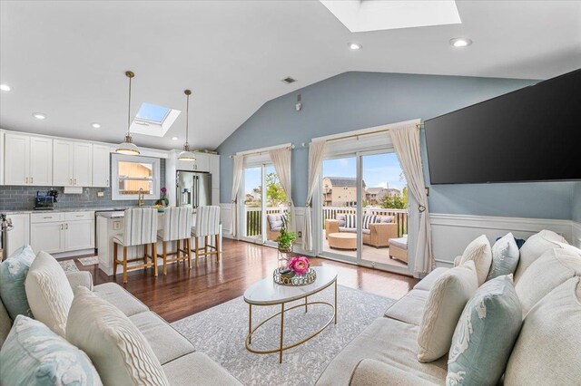 845 Atlantic St, Lindenhurst, NY 11757 - living area featuring a skylight, light wood-style floors, a wainscoted wall, vaulted ceiling, and recessed lighting