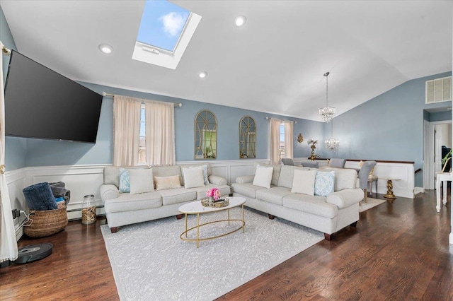 845 Atlantic St, Lindenhurst, NY 11757 - living room featuring lofted ceiling, a wainscoted wall, a chandelier, a skylight, and wood finished floors