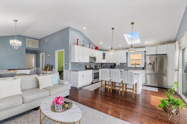 845 Atlantic St, Lindenhurst, NY 11757 - living area with a chandelier, dark wood-style floors, high vaulted ceiling, and a skylight