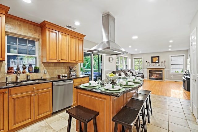 3856 Marcy St, Mohegan Lake, NY 10547 - kitchen with stainless steel dishwasher, island range hood, a breakfast bar, open floor plan, and backsplash