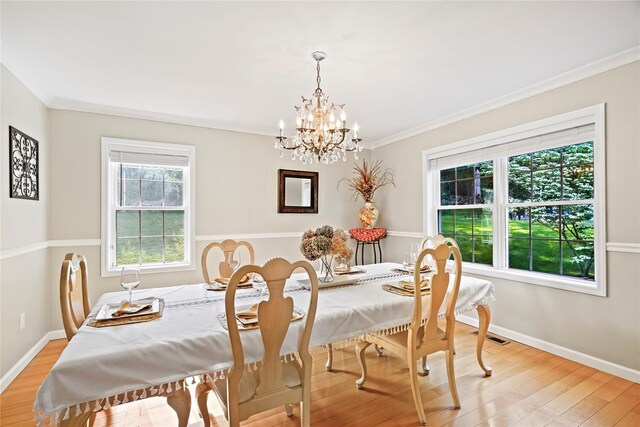 3856 Marcy St, Mohegan Lake, NY 10547 - dining room featuring a chandelier, light wood-style flooring, and crown molding