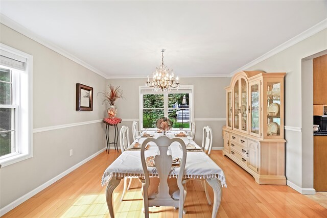 3856 Marcy St, Mohegan Lake, NY 10547 - dining space featuring a chandelier, light wood finished floors, and crown molding