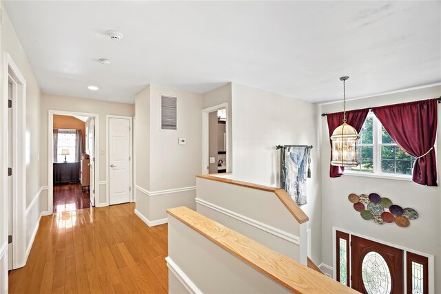 3856 Marcy St, Mohegan Lake, NY 10547 - hallway with plenty of natural light, light wood-style floors, recessed lighting, and a chandelier