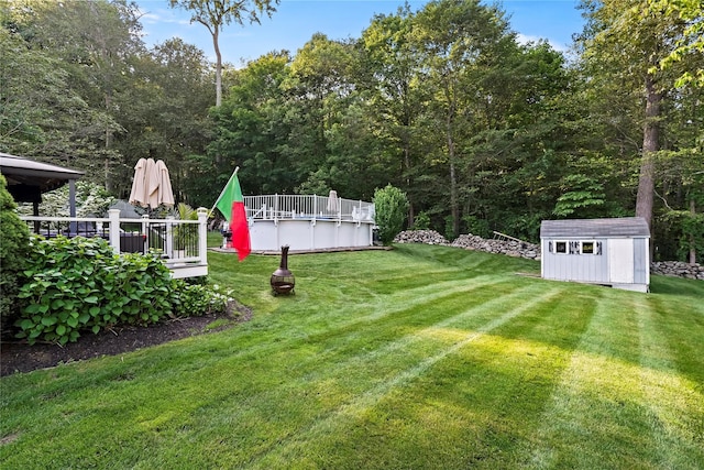 3856 Marcy St, Mohegan Lake, NY 10547 - view of grassy yard featuring a storage unit, a wooden deck, and an outdoor pool