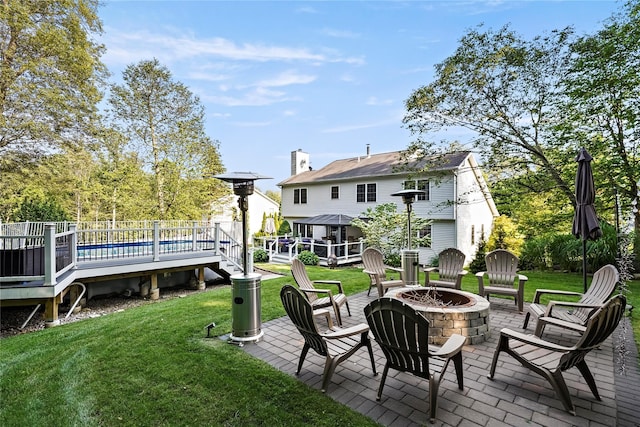 3856 Marcy St, Mohegan Lake, NY 10547 - back of house with an outdoor fire pit, a wooden deck, a patio, and a yard