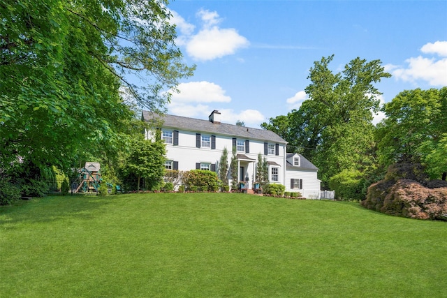 71 Baraud Rd S, Scarsdale, NY 10583 - colonial home featuring a playground, a front yard, and a chimney
