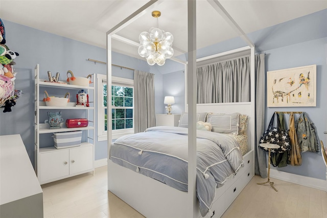71 Baraud Rd S, Scarsdale, NY 10583 - bedroom featuring light wood-style floors and a chandelier