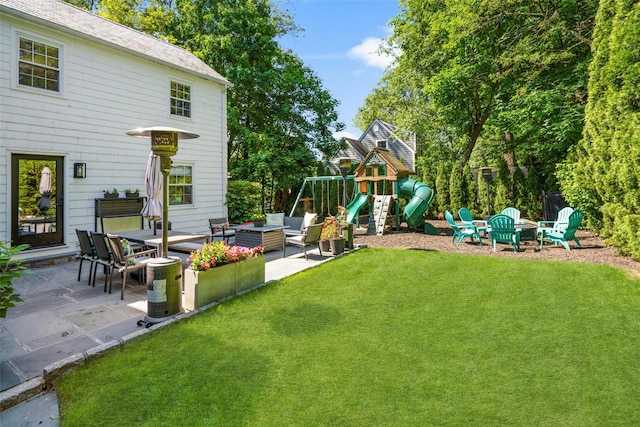 71 Baraud Rd S, Scarsdale, NY 10583 - view of grassy yard featuring an outdoor living space with a fire pit, a patio, and a playground