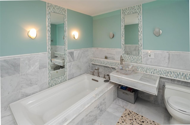 2 Sheafe Cir, Rock Tavern, NY 12575 - bathroom with tile walls, a bath, toilet, a sink, and wainscoting