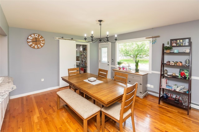 2 Sheafe Cir, Rock Tavern, NY 12575 - dining room featuring a barn door, a chandelier, light wood-style flooring, a baseboard heating unit, and baseboards