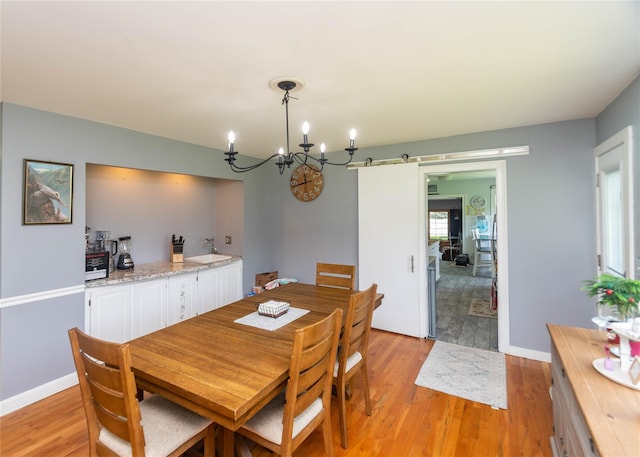 2 Sheafe Cir, Rock Tavern, NY 12575 - dining room with light wood-type flooring, a chandelier, and baseboards