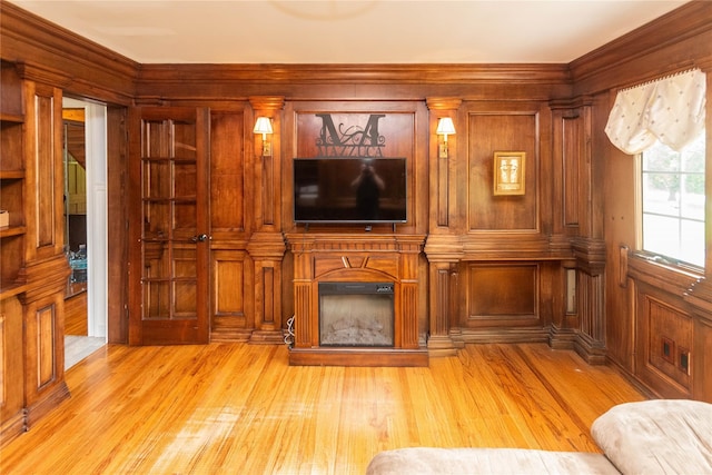 2 Sheafe Cir, Rock Tavern, NY 12575 - unfurnished living room with wood walls, light wood-style flooring, a glass covered fireplace, and ornamental molding