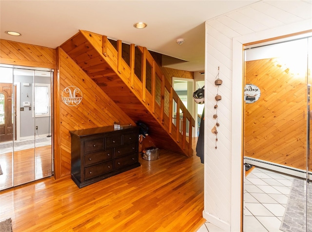 2 Sheafe Cir, Rock Tavern, NY 12575 - stairway with wooden walls, wood finished floors, recessed lighting, and a baseboard heating unit