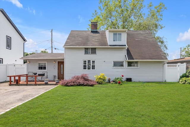 8 Trumpet Ln, Levittown, NY 11756 - rear view of house with a chimney, a deck, roof with shingles, and central AC