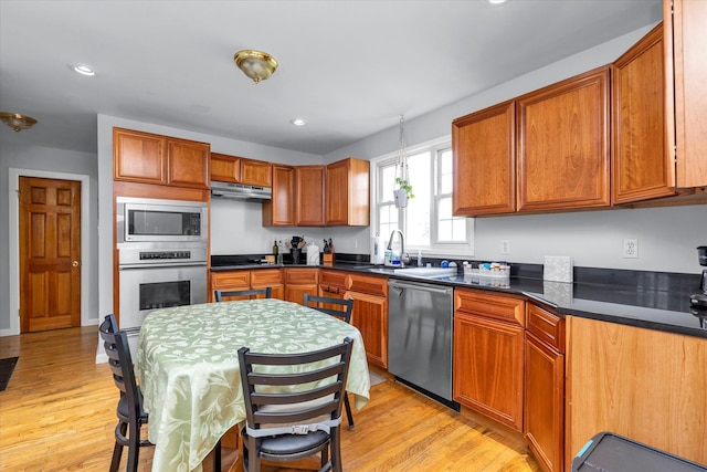 8 Trumpet Ln, Levittown, NY 11756 - kitchen featuring stainless steel appliances, a sink, light wood-style floors, dark countertops, and recessed lighting