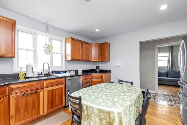 8 Trumpet Ln, Levittown, NY 11756 - kitchen with a sink, appliances with stainless steel finishes, dark countertops, recessed lighting, and light wood-style flooring