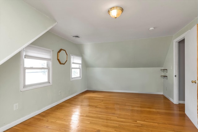 8 Trumpet Ln, Levittown, NY 11756 - bonus room with lofted ceiling, light wood-type flooring, and baseboards