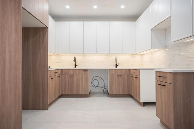 859 Myrtle Ave Apt 8G, Brooklyn, NY 11206 - kitchen featuring backsplash, light countertops, modern cabinets, recessed lighting, and white cabinetry