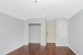 293 Wingham St, Staten Island, NY 10303 - unfurnished bedroom featuring a closet, wood finished floors, vaulted ceiling, and baseboards