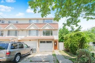 293 Wingham St, Staten Island, NY 10303 - townhome / multi-family property with driveway and a garage