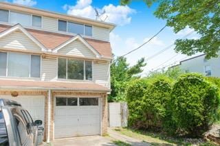 293 Wingham St, Staten Island, NY 10303 - view of front facade featuring driveway and a garage
