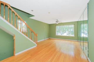 293 Wingham St, Staten Island, NY 10303 - unfurnished living room with ceiling fan, wood finished floors, and baseboards