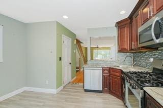 293 Wingham St, Staten Island, NY 10303 - kitchen with appliances with stainless steel finishes, backsplash, light wood-type flooring, a sink, and recessed lighting