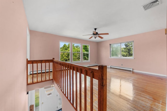 102 Maple St, Croton-On-Hudson, NY 10520 - stairs featuring a baseboard radiator, baseboard heating, ceiling fan, and wood finished floors