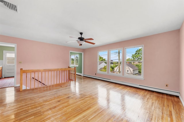 102 Maple St, Croton-On-Hudson, NY 10520 - unfurnished room with a baseboard heating unit, wood finished floors, and a ceiling fan