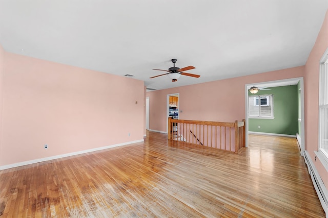 102 Maple St, Croton-On-Hudson, NY 10520 - spare room with a baseboard heating unit, light wood finished floors, and a ceiling fan