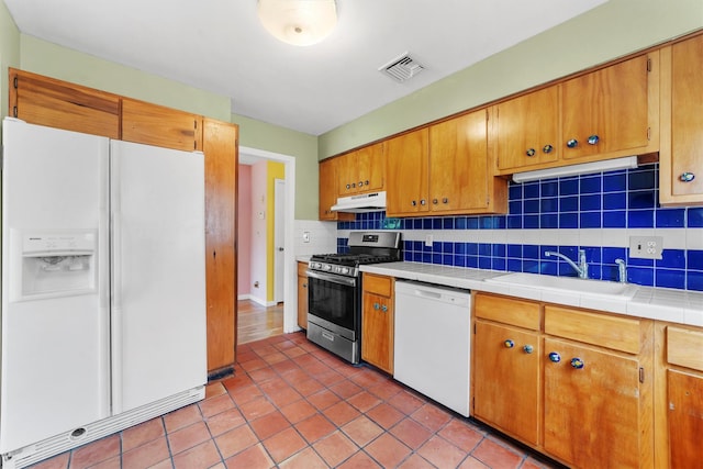 102 Maple St, Croton-On-Hudson, NY 10520 - kitchen featuring white appliances, under cabinet range hood, decorative backsplash, light tile patterned flooring, and tile countertops