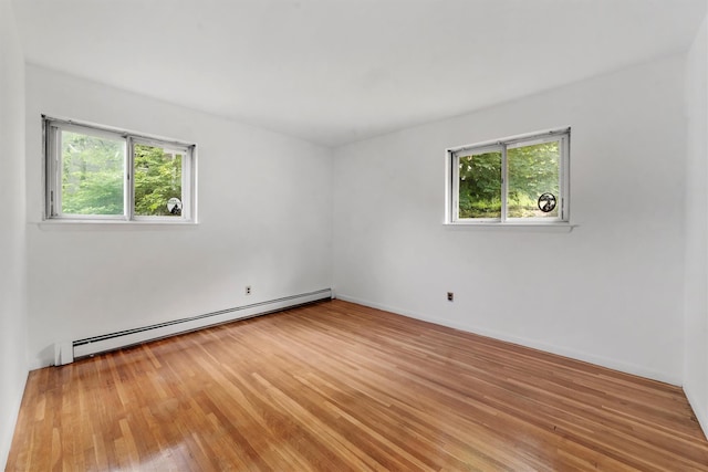 102 Maple St, Croton-On-Hudson, NY 10520 - unfurnished room featuring a baseboard heating unit, plenty of natural light, and light wood finished floors