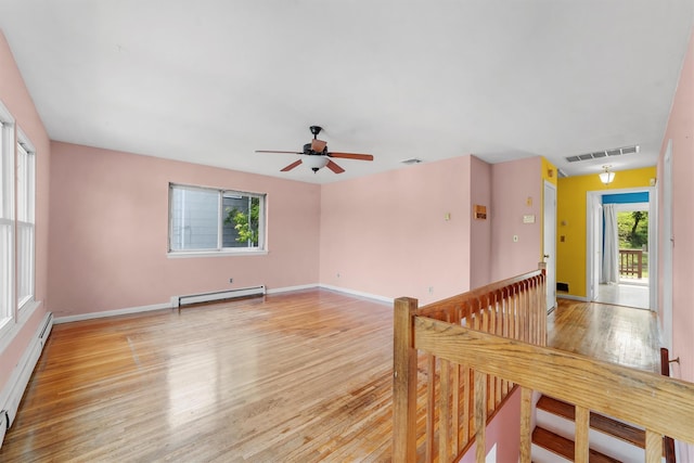 102 Maple St, Croton-On-Hudson, NY 10520 - empty room with a baseboard radiator, a baseboard heating unit, light wood-type flooring, and ceiling fan