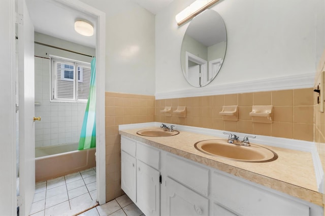 102 Maple St, Croton-On-Hudson, NY 10520 - full bathroom with double vanity, tile patterned flooring, shower / bath combination with curtain, tile walls, and a wainscoted wall