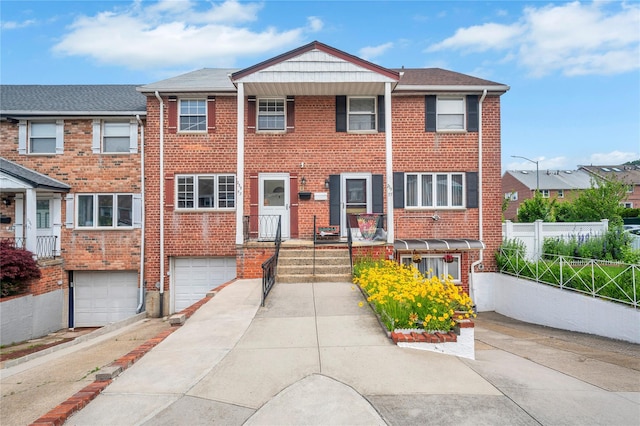 239-53 66th Ave, Little Neck, NY 11362 - view of property with a garage, brick siding, and driveway