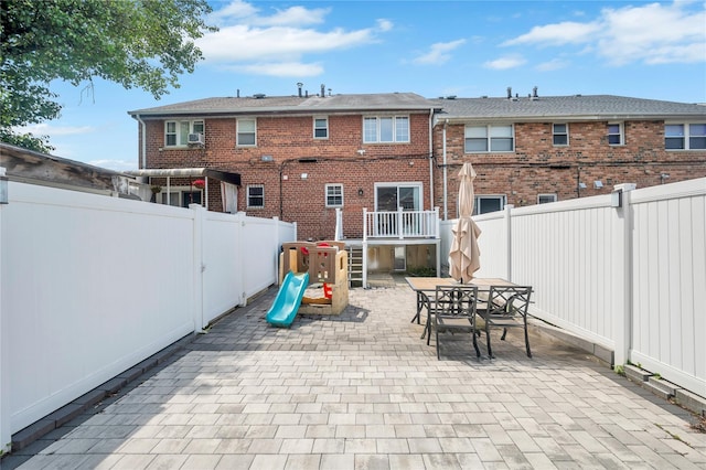 239-53 66th Ave, Little Neck, NY 11362 - fenced backyard featuring a patio, outdoor dining space, and a playground