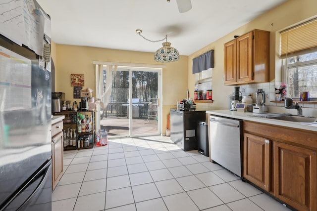 403 Haverstraw Rd, Suffern, NY 10901 - kitchen featuring refrigerator, stainless steel dishwasher, light countertops, brown cabinets, and backsplash