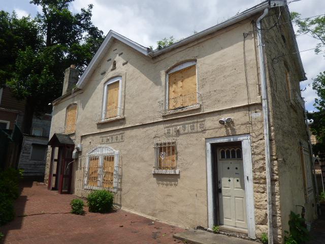 11-10 124th St, College Point, NY 11356 - view of front facade featuring stucco siding and a chimney